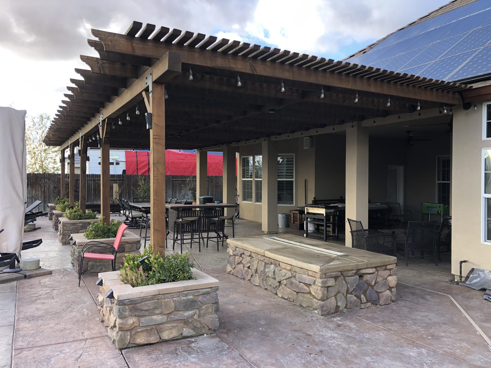 Covered patio with pergola and stone bar