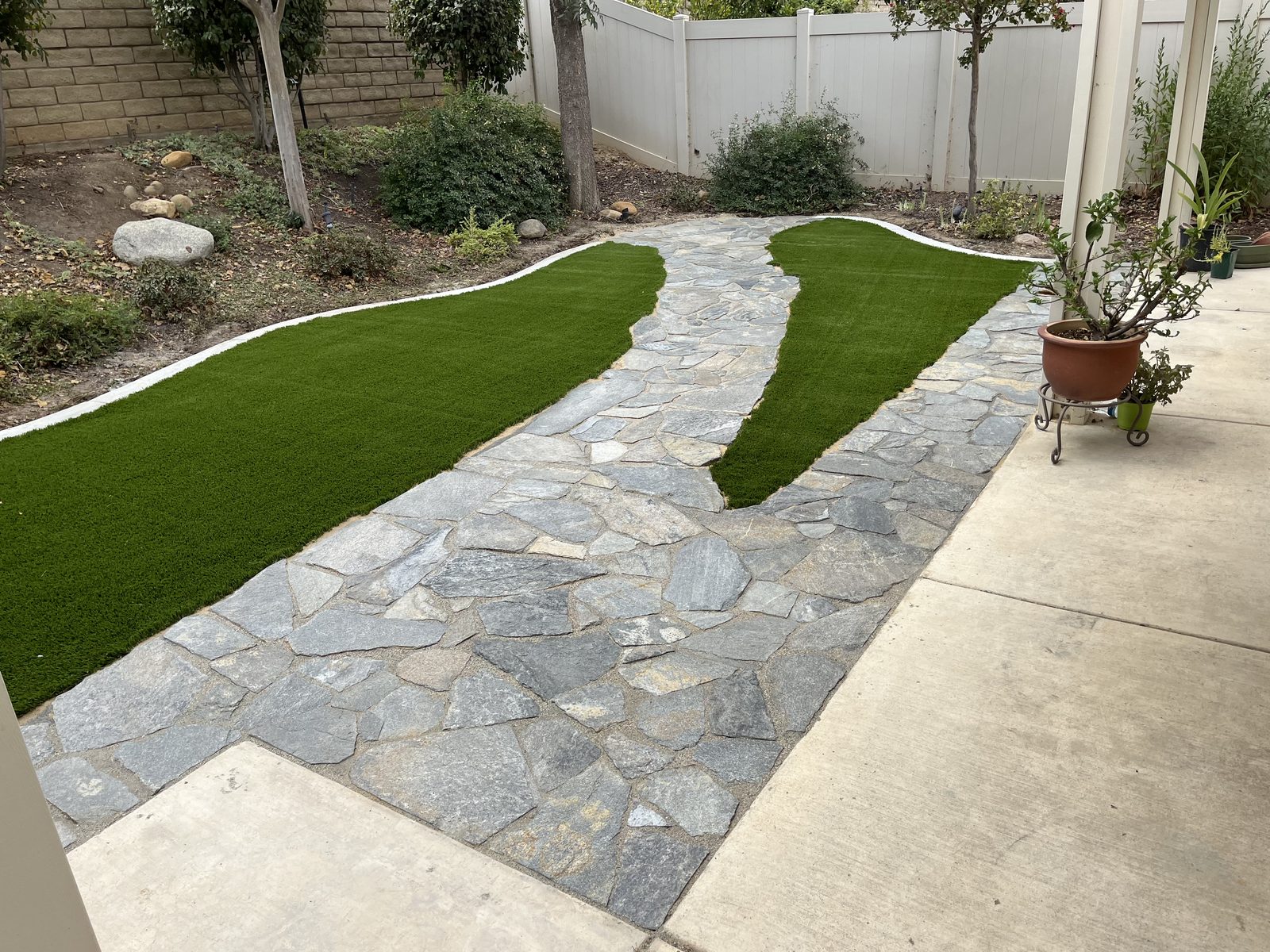 Flagstone patio with turf ribbon inlays