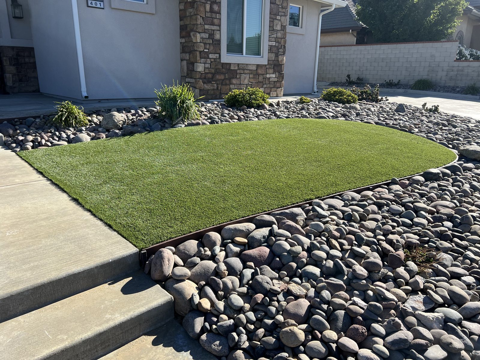 Artificial turf inset in river rock